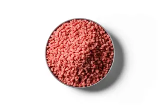 Red Granular Potassium Chloride fertiliser granules in a round dish