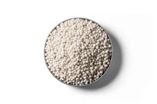 White Calcium Ammonium Nitrate (CAN) fertiliser granules in a round dish.