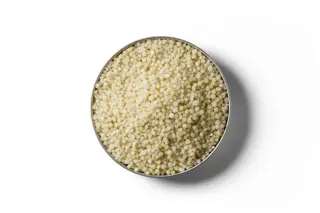 Light yellow Cropmaster DAP fertiliser granules in a round dish