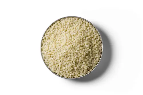 Light yellow Cropmaster DAP fertiliser granules in a round dish